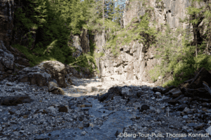 Alpenfluss und Felsen bei einer Bergwanderung.